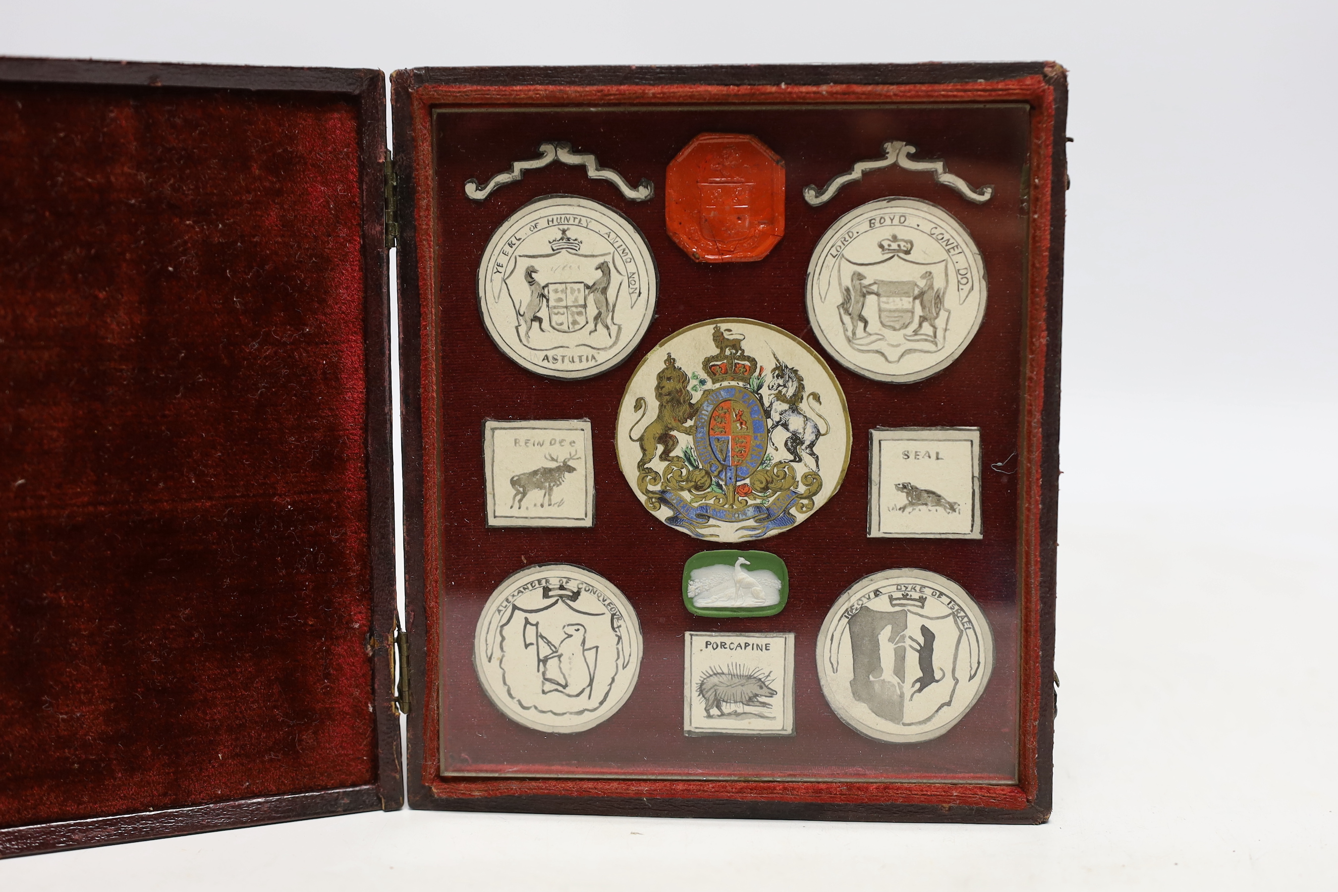 A heraldic crest display, in fitted leather case, case 15cm high, 13.5cm wide